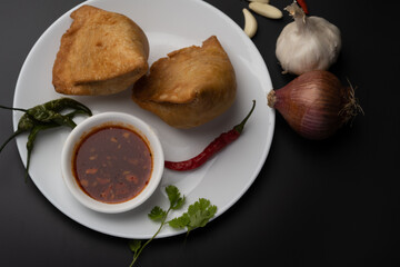 Veg Samosa - is a crispy and spicy Indian triangle shape snack which has crisp outer layer of maida filling of mashed potato, peas and spices