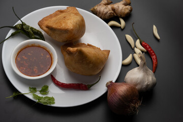 Veg Samosa - is a crispy and spicy Indian triangle shape snack which has crisp outer layer of maida filling of mashed potato, peas and spices