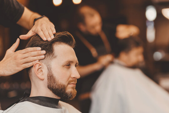 Man in barber chair, hairdresser styling hair. Concept barbershop banner, vintage color
