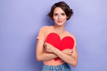 Photo of positive tender lady wear striped outfit hand hug red paper card heart symbol present gift isolated on purple color background