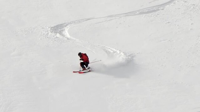 Skier rides back country, free style skiing in the deep powder snow