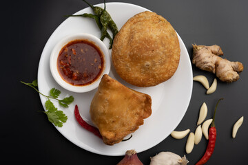 Kachori and samosa, Indian vegetarian snacks served with green and tamarind chutneys.