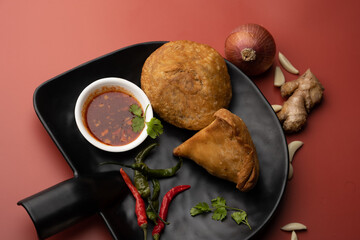 Kachori and samosa, Indian vegetarian snacks served with green and tamarind chutneys.