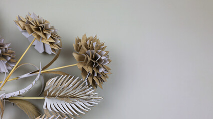 Flowers made from recycled paper on a gray background. Ecology care, making origami from toilet...