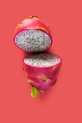 exotic fruit known as pitaya, seen from above with a pink background.