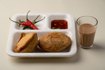 Kachori and samosa, Indian vegetarian snacks served with green and tamarind chutneys.