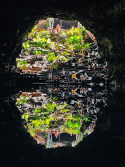 People on steps outside cave