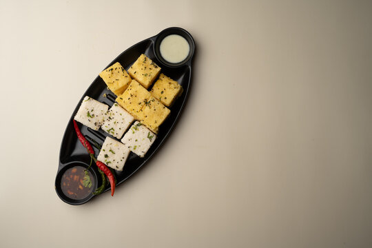 Indian popular Gujrati breakfast dish White Dhokla, Khatta , Rice and Urad Dal Khaman. Also known as Instant Rava Dhokla AND yellow dhokla or besan gram flour. served with ketchup 