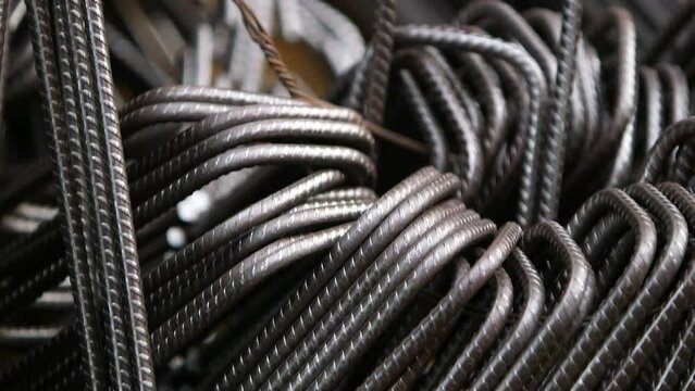 Steel rods in shape - Close-up view on an arrangement of rebar links with camera focusing on the galvanized wire on it.
