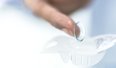 Closeup index finger with contact lens for eye vision problem people,  Optical Glasses Concept