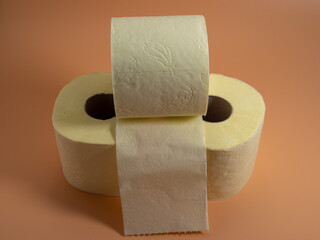 Roll of Toilet paper on an orange background.