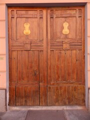 old wooden door inlaind with wooden violins decorations