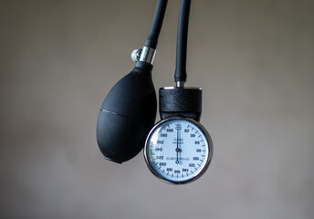 close up image  of aneroid manometer and inflation tube of a sphygmomanometer 