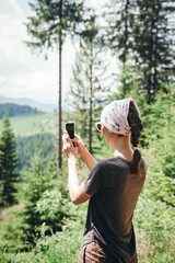 woman with a camera. The girl takes pictures of mountain landscapes