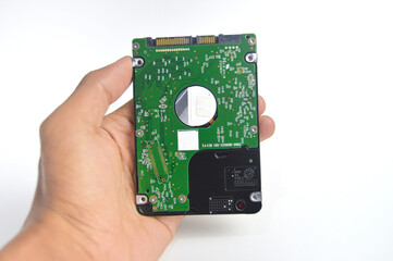  computer hard drive in someone's hands on white background