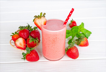 Strawberry yogurt fruit juice smoothie pink colorful fruit juice milkshake blend beverage healthy high protein the taste yummy In glass drink episode morning on white wood background.