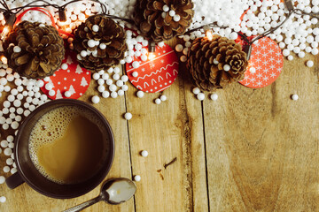Christmas decorations and coffee mugs on wooden table for background