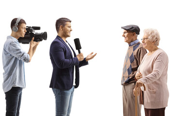 Cameraman and a reporter interviewing elderly cistizens