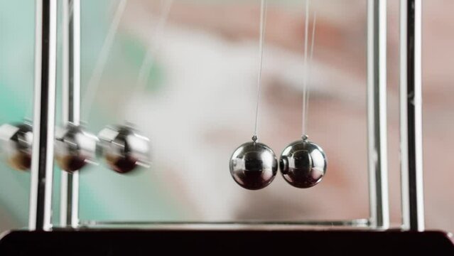 Newton balls close-up, five metallic pendulums colliding, cradle. Physics and science concept.