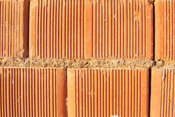 Red ceramic bricks close up. Keramoblock. Red brick wall texture background