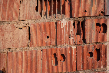 Old red ceramic bricks close up. Keramoblock. Red brick wall texture background