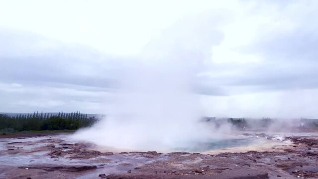 Strokkur geyser eruption, Geysir, Haukadalur valley on the slopes of Laugarfjall hill, southwestern Iceland