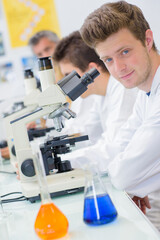 a male student with microscope