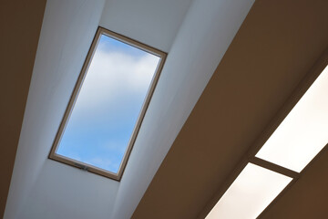 Modern, insulating skylight window and energy-saving LED lighting panels on the ceiling. Color illustration photo of natural light or new environment friendly technologies.