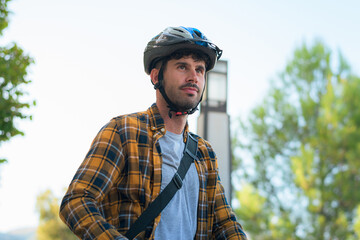 Portrait of a young man riding an electric scooter with a helmet