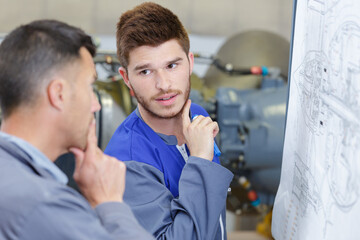 Fototapeta premium two male engineers looking at scale diagram