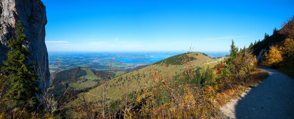 autumnal hiking trail Kampenwand mountain with view to lake Chiemsee, upper bavaria