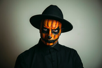 halloween witch with a pumpkin. Pumpkin face. Halloween photo. Male. 