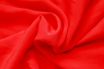 Close-up abstract texture red color fabric cloth textile background, cotton wavy material, soft folds waves on the fabric. Macro, web theme, template, wallpaper, concept design, for your design