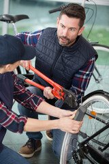 Fototapeta na wymiar men repairing a broken bicycle outdoors
