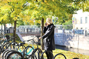 Fototapeta na wymiar young man walking in the park, riding a bicycle on a warm sunny autumn day