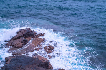 Water of the Atlantic Ocean breaking over rocks - water breaking on rocks