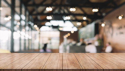 Empty wooden table top with lights bokeh on blur restaurant background.	