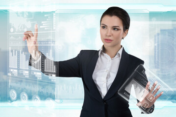 Young business lady works with virtual graphic interface in futuristic office