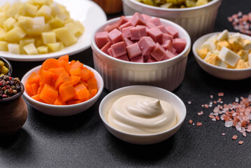 Delicious fresh Olivier salad with sausage, egg, cucumber, green peas, carrots and mayonnaise