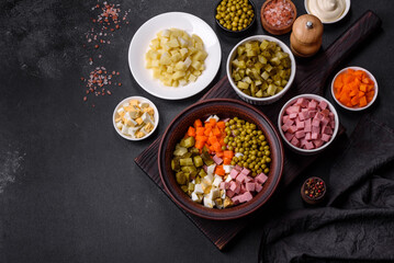 Delicious fresh Olivier salad with sausage, egg, cucumber, green peas, carrots and mayonnaise