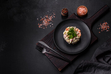 Delicious fresh Olivier salad with sausage, egg, cucumber, green peas, carrots and mayonnaise