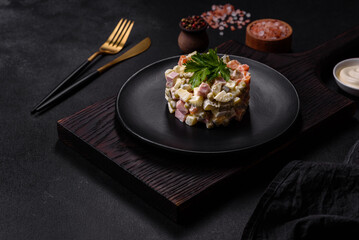 Delicious fresh Olivier salad with sausage, egg, cucumber, green peas, carrots and mayonnaise