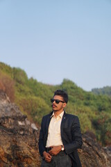 man wearing sui posing near beach