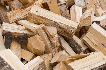 A pile of fallen firewood for heating the stove. The concept of the energy crisis in the Euro.