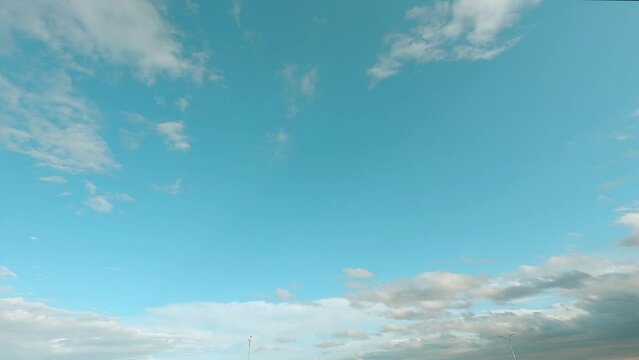 blue sky with clouds, nature 4k time lapse background. the natural landscape of romantic clouds with copy space in middle of the screen. 4k b-roll footage joy n peaceful environment