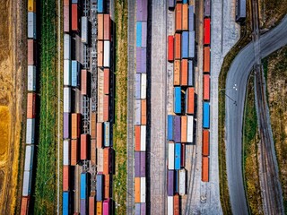 Top view of colorful freight trains on the railway station