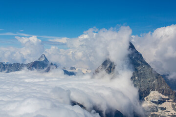 Fototapeta na wymiar Beautiful alpine scenery in the Swiss Alps in winter, with dramatic cloudscape