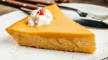 A slice of pumpkin cheesecake pie with whipped cream, Food recipe background. Close up