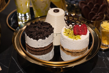 Pastries with Whipped Cream, Fruit, Cream and Chocolate displayed on a Tray in a Pastry Shop