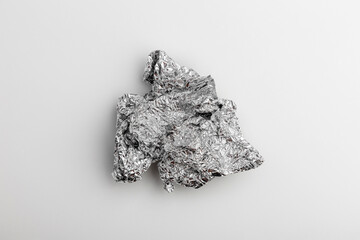 a piece of crumpled foil on a gray background